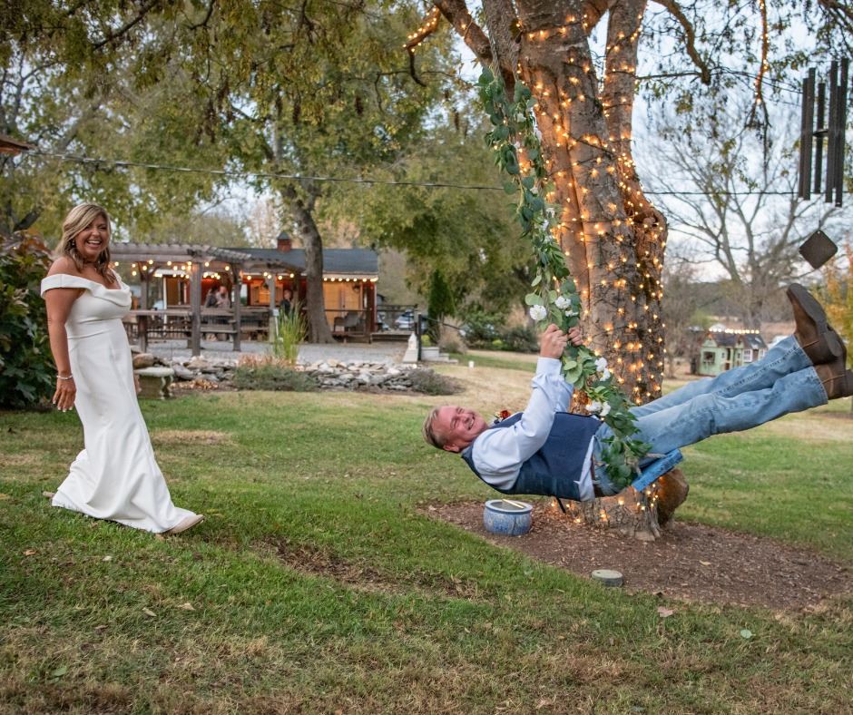 groom on tree sing while bride laughs