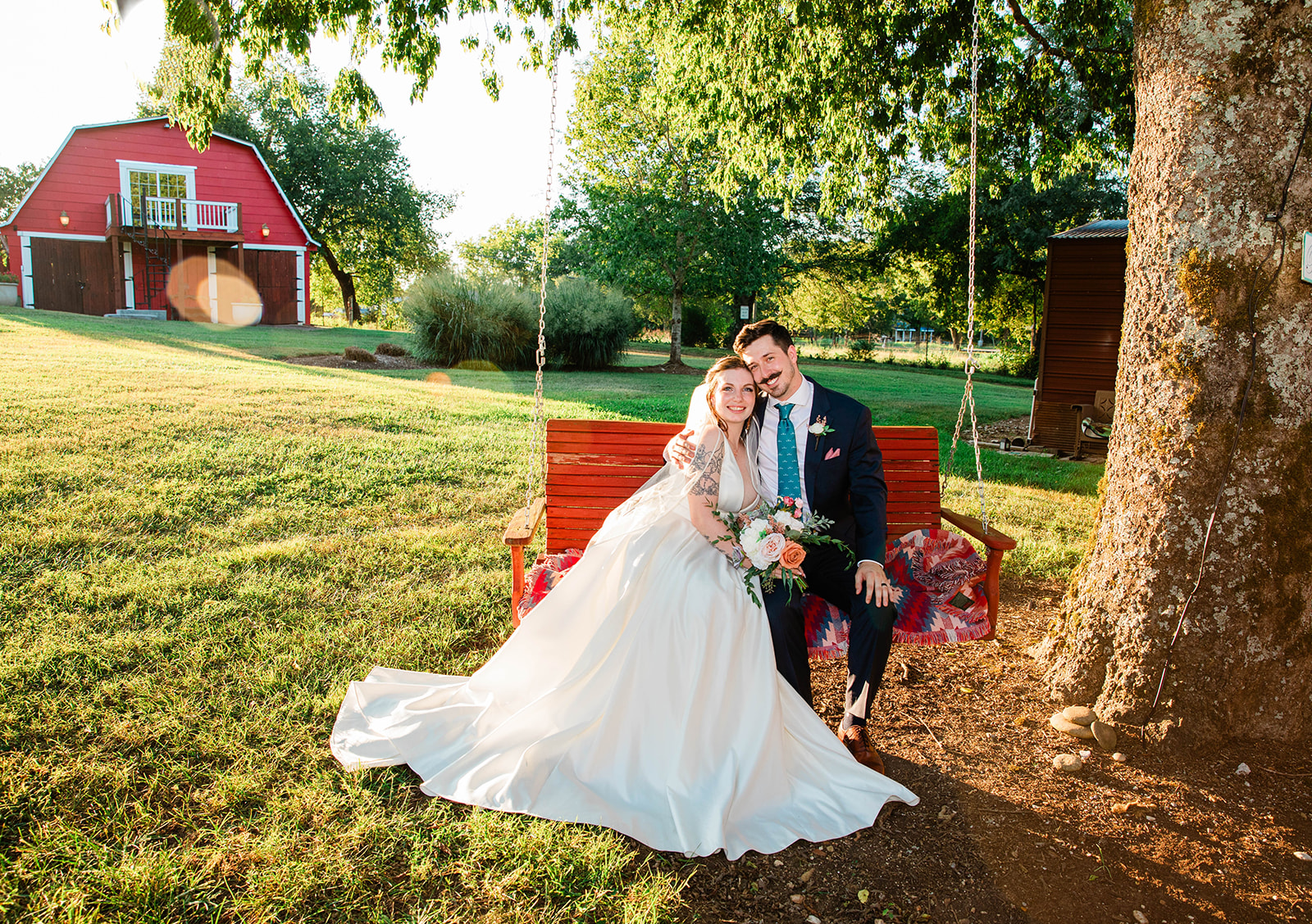 bride and groom on bench swing