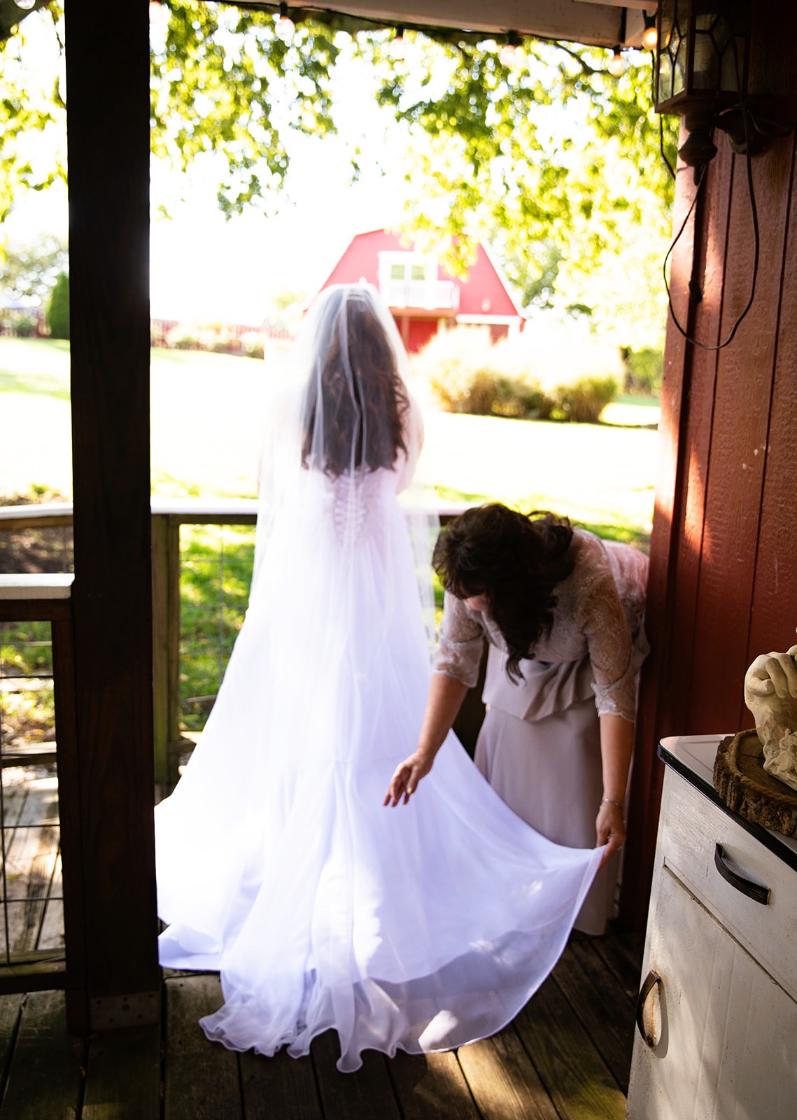 mother fixing bride's gown