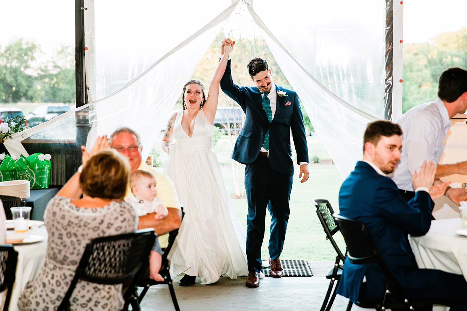 bride and groom holding hands walking into wedding reception